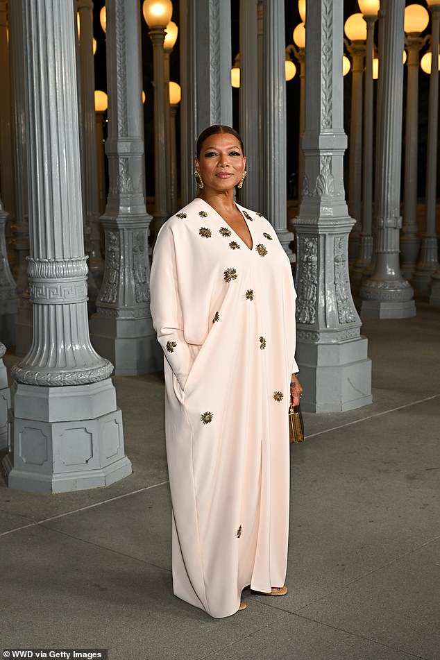 Queen Latifah stood out in a cream-colored dress decorated with randomly spaced gold flower petals