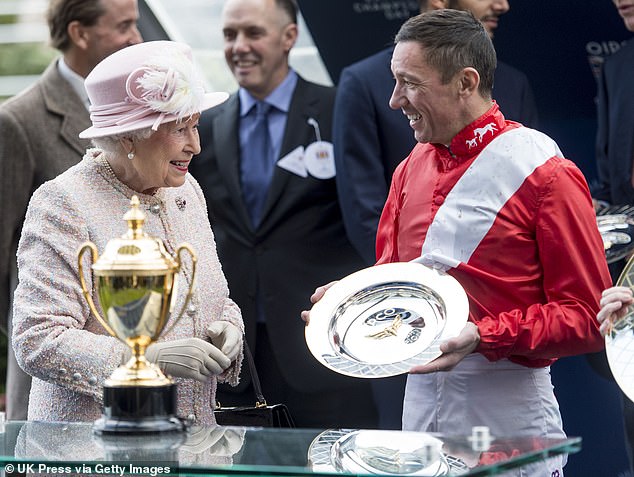 Queen Elizabeth II presents Dettori with a winners prize at Ascot Racecourse in October 2017