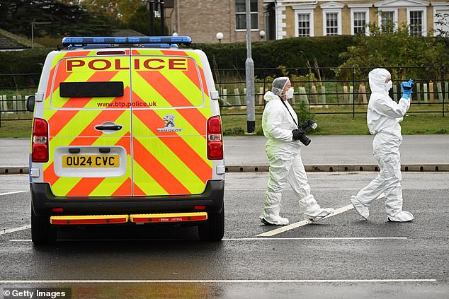 Forensic police officers attend the scene at Huntingdon station on Sunday morning following the major incident  the previous evening