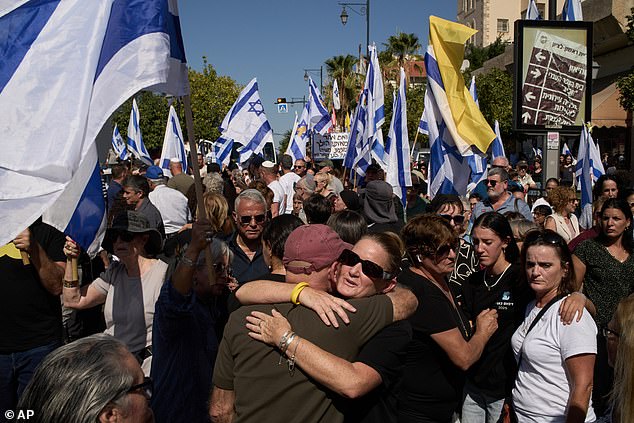 Relatives and friends mourn as they walk near the car carrying the coffin of slain hostage Yossi Sharabi during his funeral procession in Rishon LeZion, Israel last week