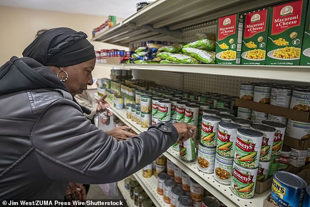 People pick up groceries at the nonprofit Deo Gratias Food Pantry in Detroit