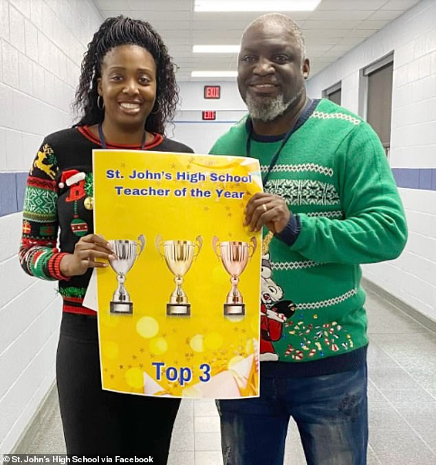 Nelson and the school principal holding up the Top 3 best teacher of the year poster in December 2024