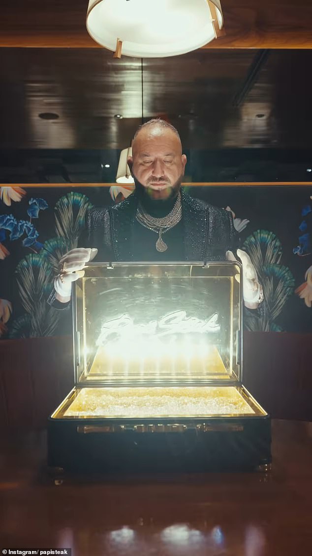 The golden briefcase full of glittering ice has the restaurants' name emblazoned on the lid