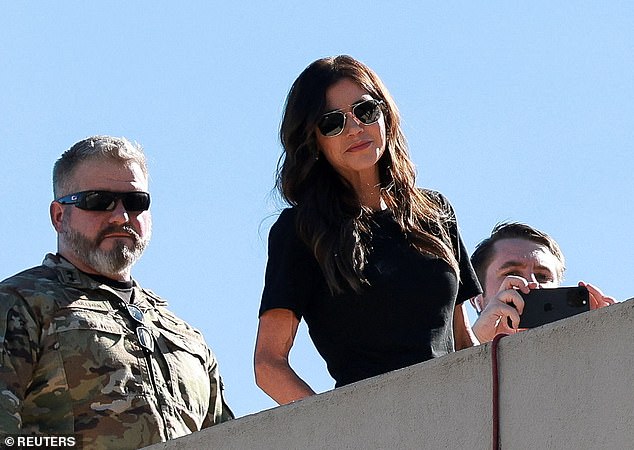 Homeland Security Secretary Kristi Noem looks on from the roof of the U.S. Immigration and Customs Enforcement (ICE) headquarters in Portland, Oregon on October 7, 2025