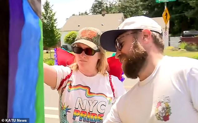 Kylie Forslund (left) and her husband Eric (right) were seen hanging posters urging customers to boycott Cathedral Coffee outside the restaurant in June this year