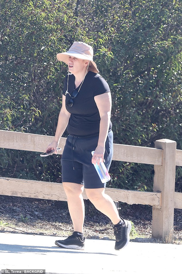She came prepared to break a sweat with a floppy hat and bottle of chilled water