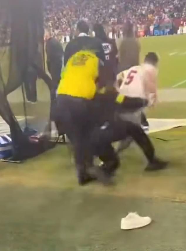 The same fan was later seen running onto the field before being tackled by security