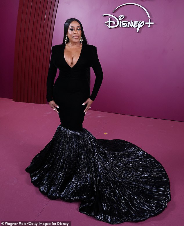 Nash-Betts showcased substantial cleavage in a plunging black gown featuring a trumpet train