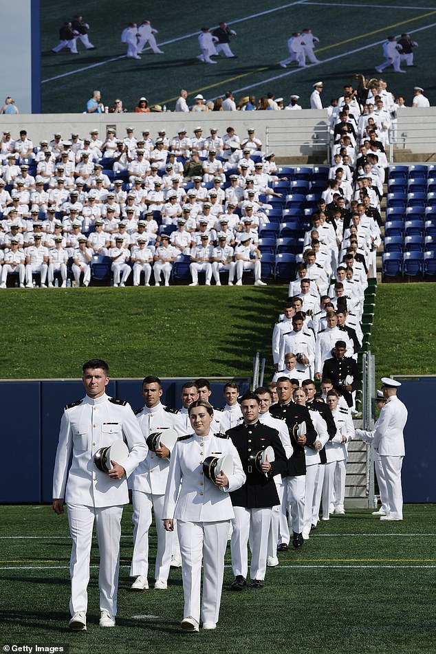 The unnamed servicemember - who has served for over two decades - was just two weeks away from being named to the post when the Pentagon revoked her orders (pictured: US Naval Academy midshipmen walk in pairs for their graduation ceremony in Maryland, 2024)
