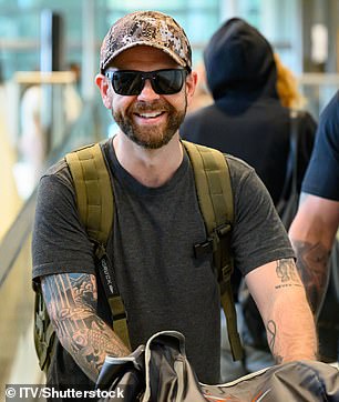 ... while her brother Jack prepares to get his hands dirty in the Australian jungle (pictured at Brisbane Airport on Wednesday)