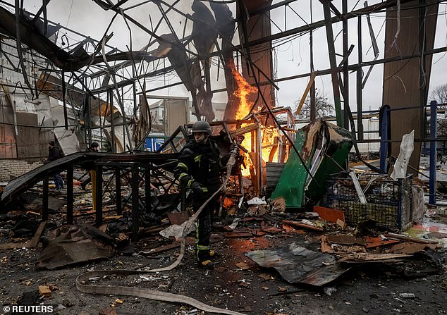 A firefighter works at the site of a Russian drone strike, amid Russia's attack on Ukraine, in Kharkiv, Ukraine November 12, 2025