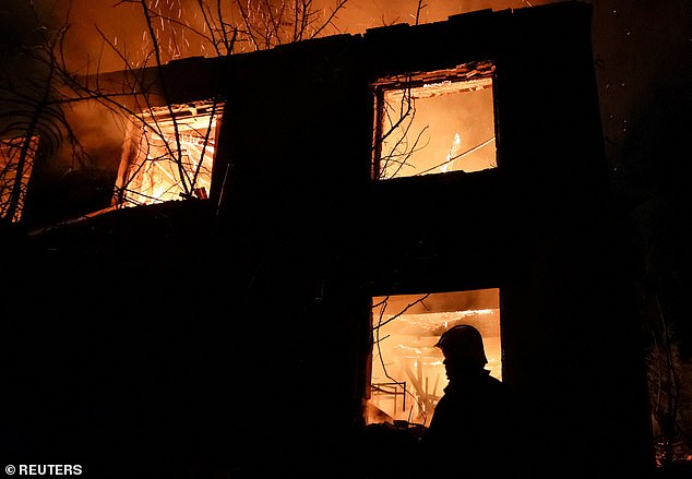 A firefighter works at the site of a Russian drone strike, amid Russia's attack on Ukraine, in Chuhuiv, Kharkiv region, Ukraine November 7, 2025