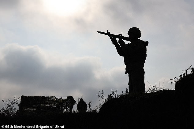 A Ukrainian recruit learns how to fire a RPG-7 grenade launcher at an undisclosed location on November 5, 2025