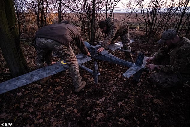 Pilots from the Predator Brigade's unmanned vehicle unit of the Ukrainian Patrol Police in Donetsk assemble a GARA bomber drone on a nighttime strike mission against Russian forces on the Pokrovsk front line, Ukraine, November 2 2025
