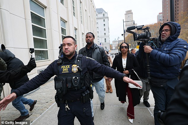 Police officers pave a way for the Cleveland Guardians pitcher as he makes his way into court