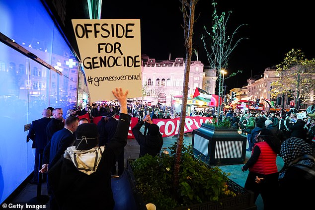 They held banners which read ‘You are complicit’ and ‘Offside for genocide’, among others