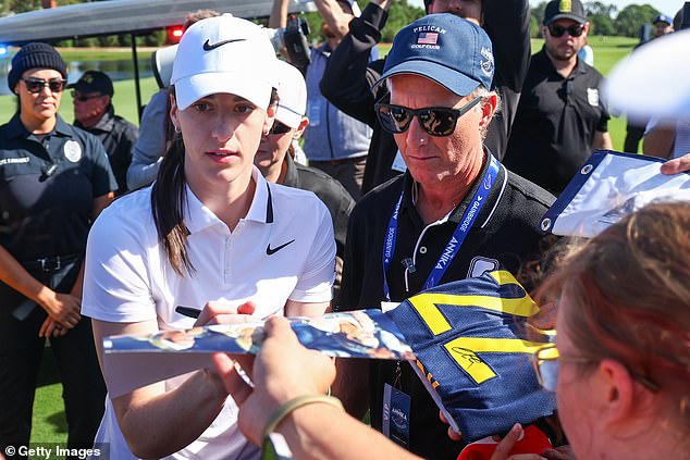 The Indiana Fever guard signs autographs for clamoring fans before teeing off