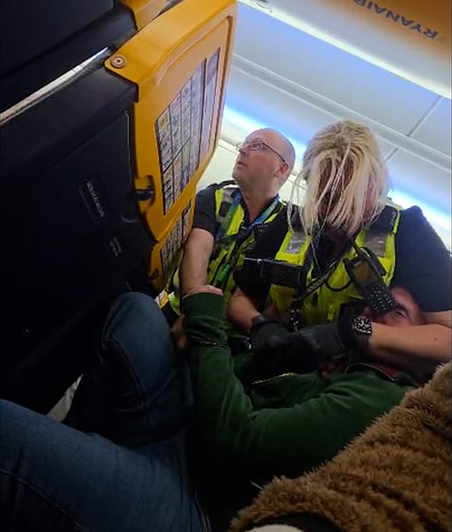 Footage filmed by fellow passenger Kacper Bujak shows the man swearing, arguing with cabin crew and fighting security staff as they tried to restrain him