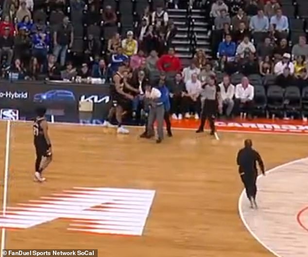 The fan was eventually wrapped up by security before being escorted off the court