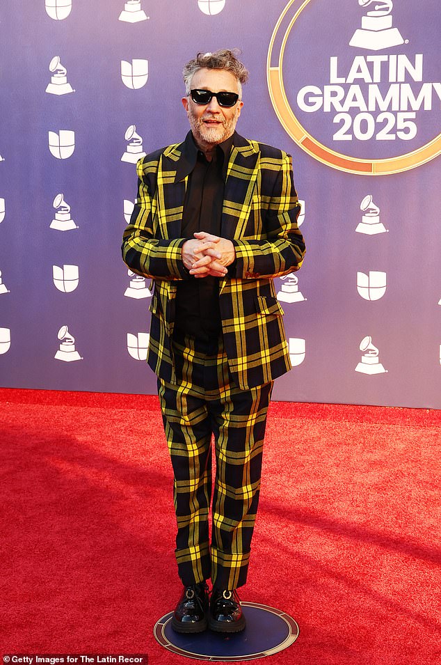School uniform vibes! Filmmaker Fito Páez arrived to the red carpet in a black-and-yellow plaid suit with cuffed pant legs. He paired a black shirt under the jacket, along with a pair of shiny, platform black shoes. He topped the look off with a pair of black sunglasses