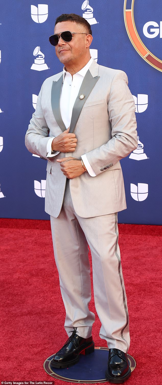 Tracksuit or tuxedo? Alejandro Sanz wore a gray suit with a satin pinstripe along the sides of the pants, which made the outfit look more like a tracksuit than a tuxedo. He accessorized with a pair of black aviator-style sunglasses and glossy, black platform shoes