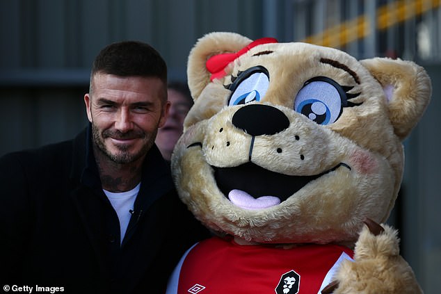 Beckham poses with the Salford City mascot. The significance of Beckham as part of the Ammies' appeal has become clear at meetings of the new ‘members club’