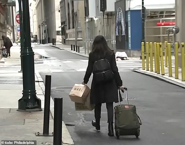 A guest is seen abruptly leaving the Sonder hotel she was staying at in Philadelphia with her luggage in tow