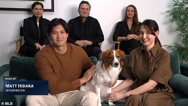 Ohtani, Decoy and Mamiko Tanaka sit on a couch as he learns he's won another MVP award
