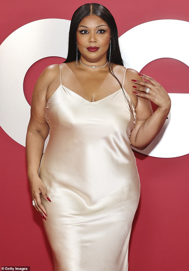 The singer added a silver necklace and matching dangly earrings to the look, while also opting for a dark red tint to her lips