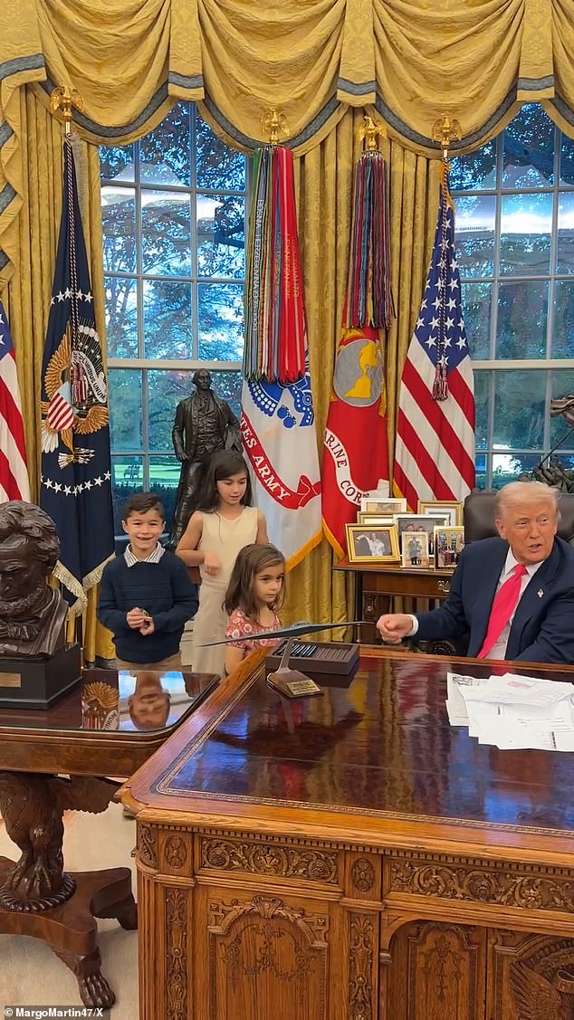 The children could be seen laughing as the president hands them gifts inside the Oval Office