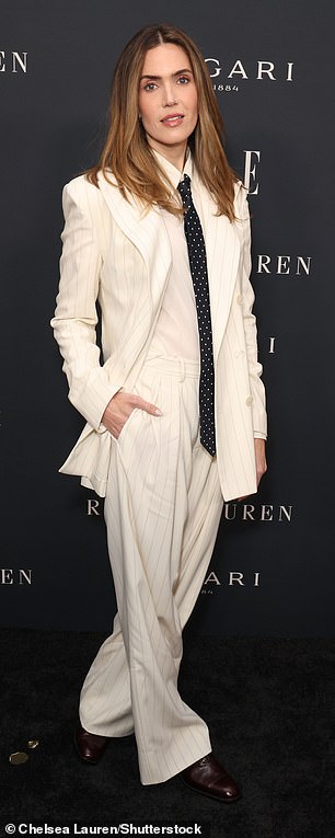 Her brunette tresses were parted in the middle and styled straight