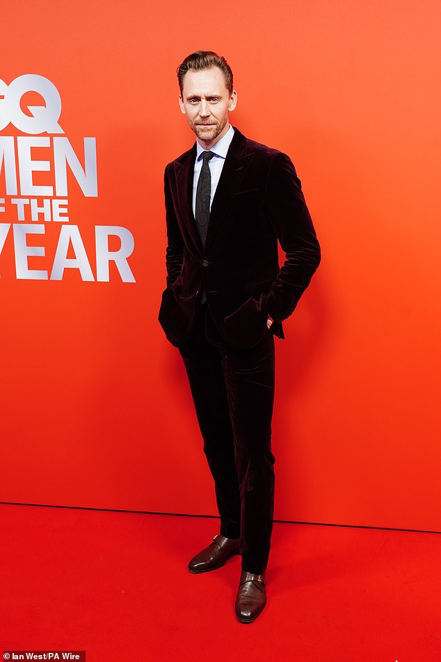 Pierce rocked a pinstripe suit, which he teamed with a tailored coat and purple aviators