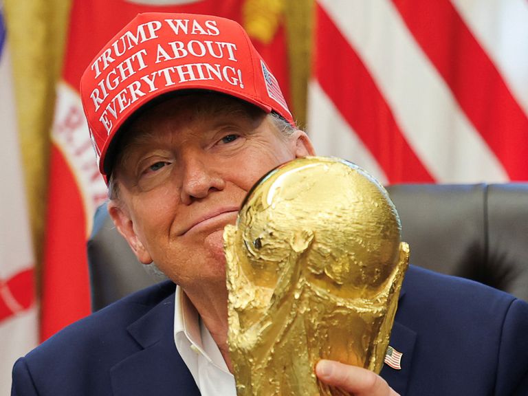 US President Donald Trump holding the FIFA World Cup trophy. Pic: Reuters
