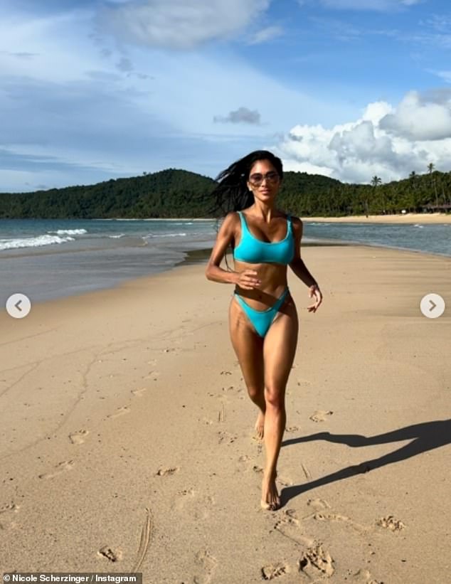 The singer, 47, flaunted her jaw-dropping figure in tiny turquoise two-piece as she posed up a storm on an idyllic beach surrounded by a forest of palm trees