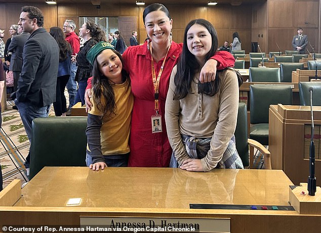 Hartman (pictured with her daughters) said that despite the grim news, her medical team was optimistic and she would be starting treatment in December