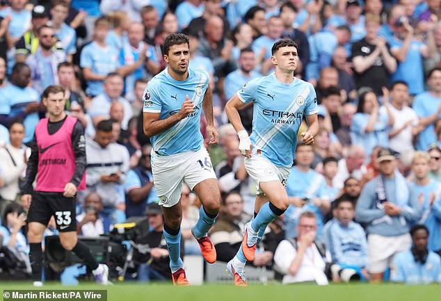 Rodri (left) and Phil Foden's contracts expire in 18 months' time - the Spaniard may have to wait for a new deal while he continues to fully recover from last season's knee injury