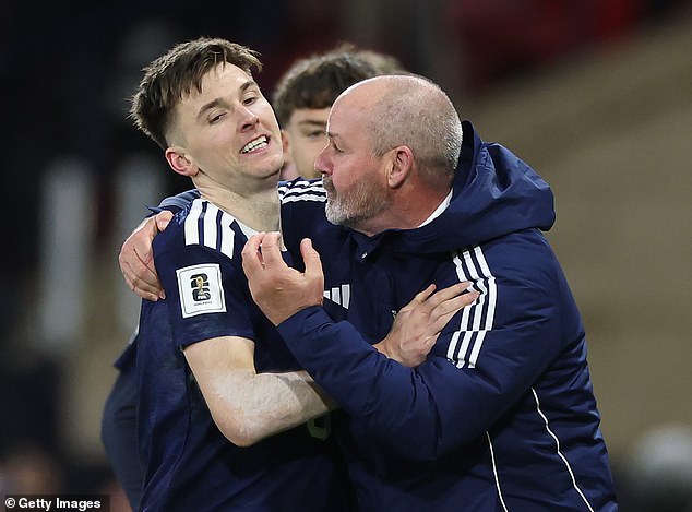 Kieran Tierney is embraced by the Scotland boss after his goal made in 3-2 against Danes