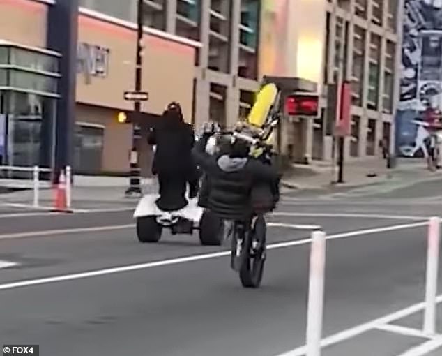 Individuals on a dirt bike and an ATV are seen here carelessly popping wheelies in the downtown area of the city earlier this year