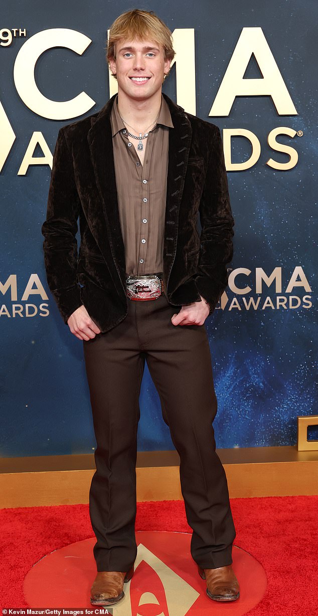 Casual cowboy vibes! Artist Hudson Westbrook looked like he was going to a chilled outing as he wore a pair of slacks and a velvet jacket to the red carpet. He kept his look simple with a pair of beat-up, brown leather cowboy boots and a large silver cowboy-style belt. He completed his look with some silver chains and necklaces