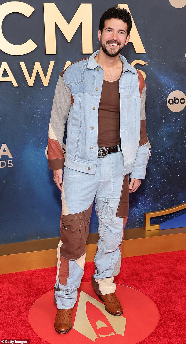 Confused much? Singer Ben Johnson wore a denim, patchwork suit to the red carpet, which featured different jean hems in various colors sewn together. The look was completed with a pair of brown cowboy boots, a black cowboy-style belt, and a brown tank top underneath his jacket
