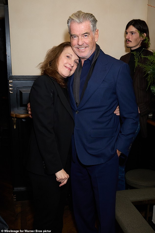 Pierce looked suave in a navy suit as he posed with Barbara Broccoli