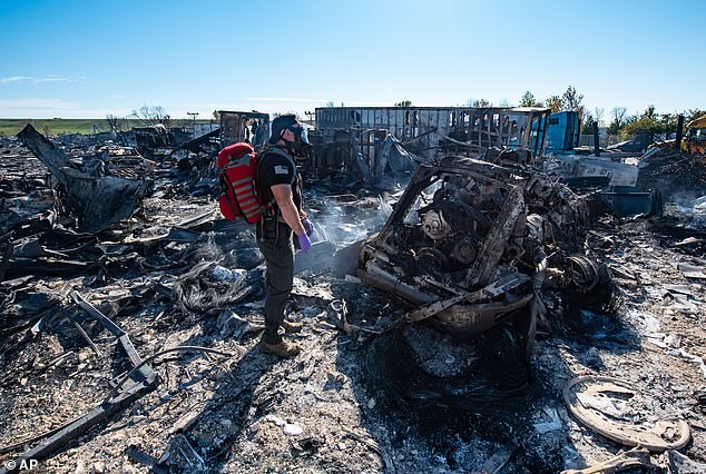 A member of the US Air National Guard is seen surveying the horrible damage left behind from the crash on November 5