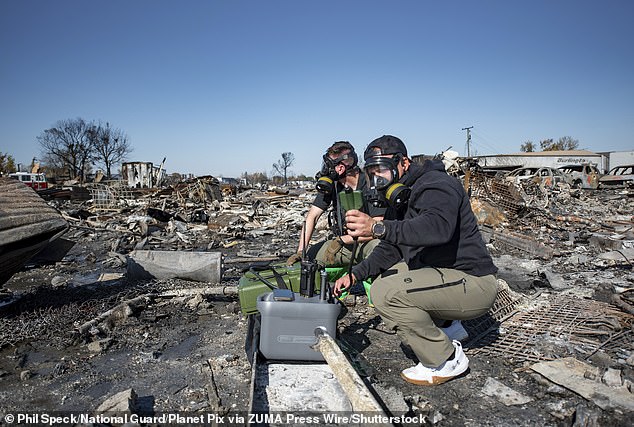 The NTSB's report on Thursday revealed the first new details about the deadly crash since November 7. Members of Kentucky National Guard 41st Civil Support Team are pictured using a portable gas chromatograph mass spectrometer to test for airborne toxic chemicals