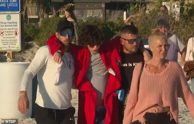 Even though he struggled to walk on the sand, Speck told his loved ones that he didn't want to postpone the baptism