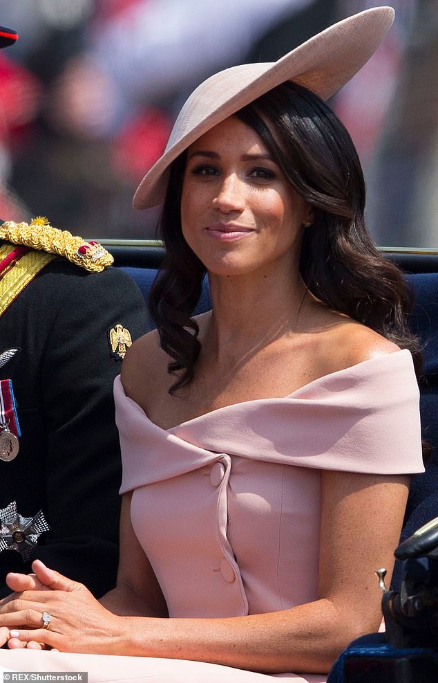 This look appeared to be a source of inspiration for Meghan's Trooping the Color ensemble in 2018, when she wore a light pink Carolina Herrera dress with a similar neckline and button detailing