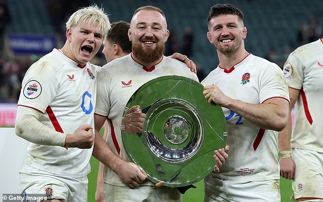 Curry celebrates beating New Zealand last week with Henry Pollock (left) and Joe Heyes. Curry, part of England's 'Pom Squad', is embracing his role