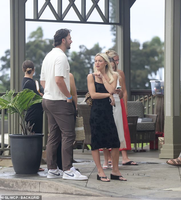 She was wearing a stylish black dress and matching shoes, while Skenes pulled on a casual white T-shirt, brown pants and white Nike sneakers
