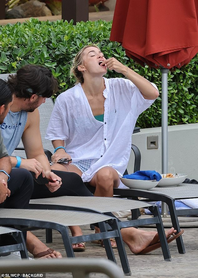 Dunne was spotted tucking into some food after pulling on a casual white shirt later in the day