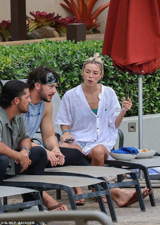 The former athlete and her boyfriend appeared to be deep in conversation with a friend