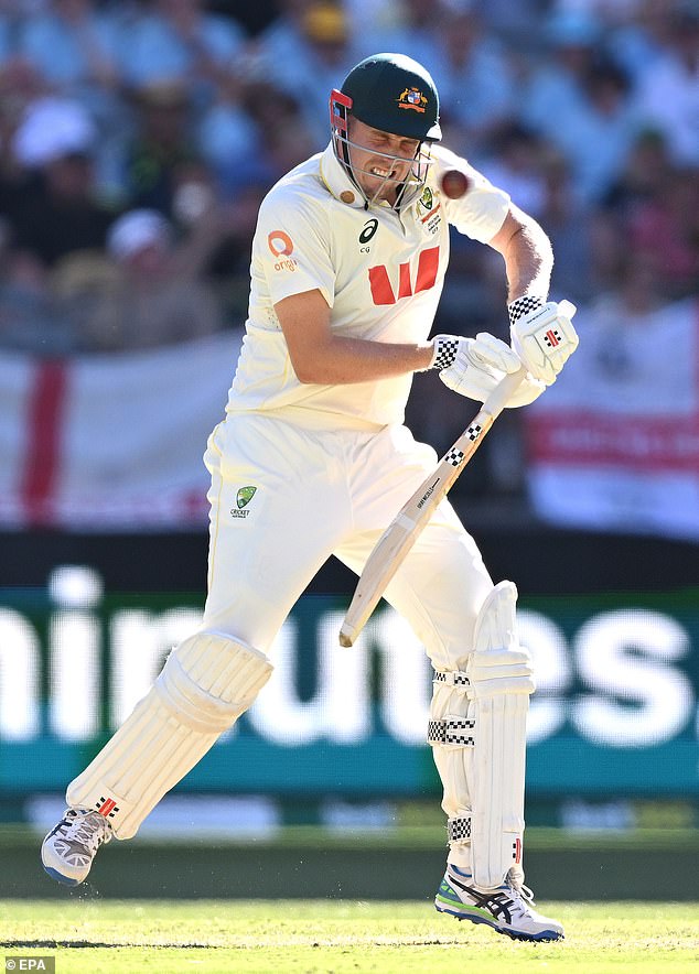 Cameron Green is smashed in the helmet by a Mark Wood short ball in Perth on day one